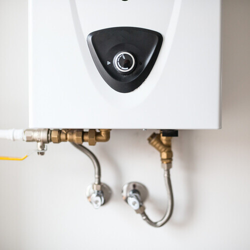 a tankless water heater against a wall